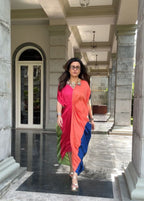 Woman in a colorful saree standing in a marble hallway